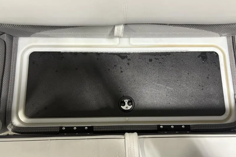 Slide: The Image of 2023 Regency 230 DL3 boat storage compartment with water droplets on the lid. - 14