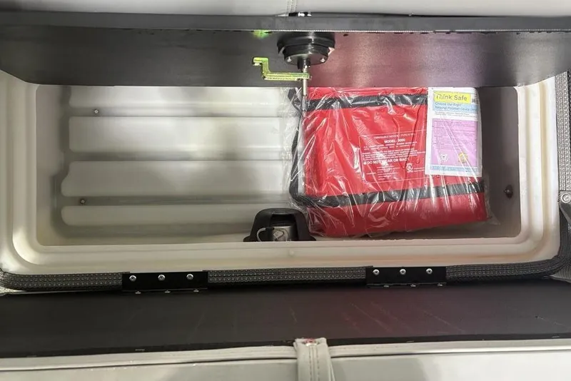 Slide: The Image of Storage compartment of 2023 Regency 230 DL3 with safety equipment inside. - 15