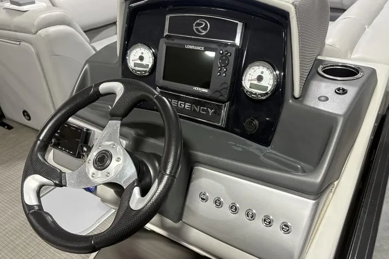 Slide: The Image of 2023 Regency 230 DL3 boat dashboard with steering wheel and control panel. - 23