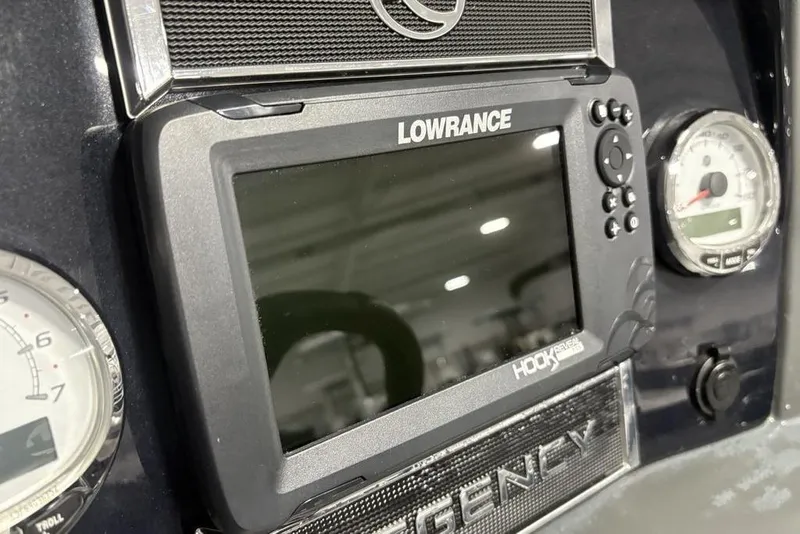 Slide: The Image of Dashboard of 2023 Regency 230 DL3 with Lowrance Hook Reveal display and gauges. - 25