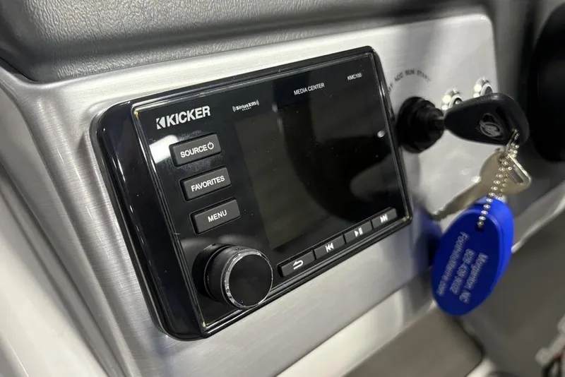 Slide: The Image of Kicker media center in 2023 Regency 230 DL3 boat dashboard with keys. - 28