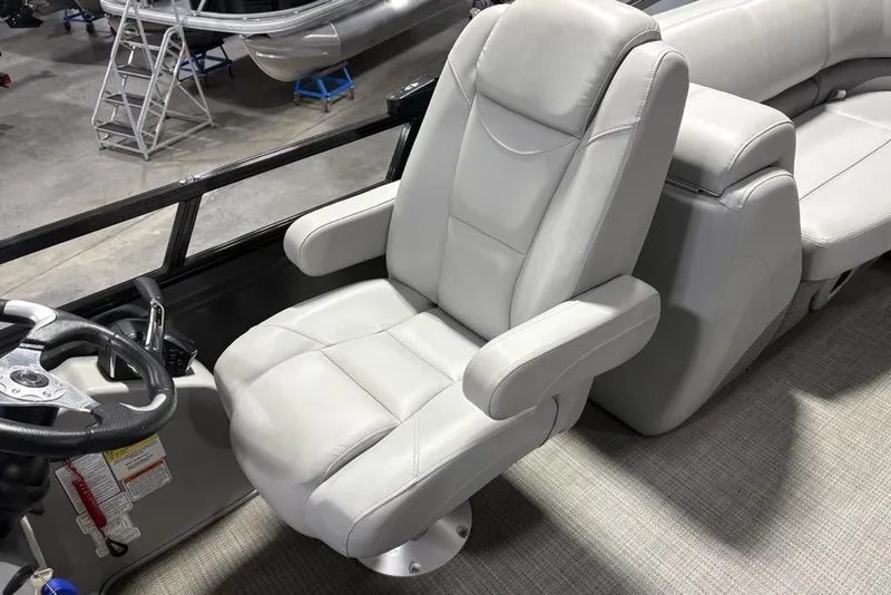 Slide: The Image of Captain's chair in 2023 Regency 230 DL3 boat, featuring plush gray upholstery. - 29