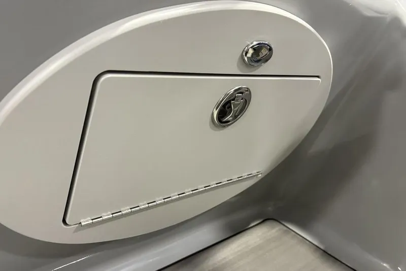 Slide: The Image of Close-up of a 2023 Regency 230 DL3 boat compartment with lock and hinge. - 30