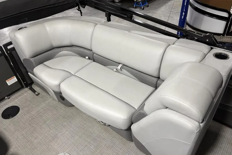 Slide: The Image of 2023 Regency 230 DL3 boat interior with plush gray seating and cup holder. - 33