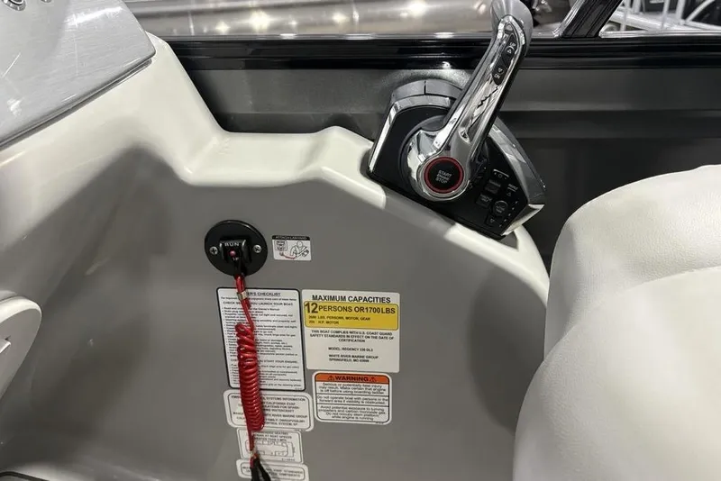 Slide: The Image of Control panel of 2023 Regency 230 DL3 boat with safety labels and throttle lever. - 35