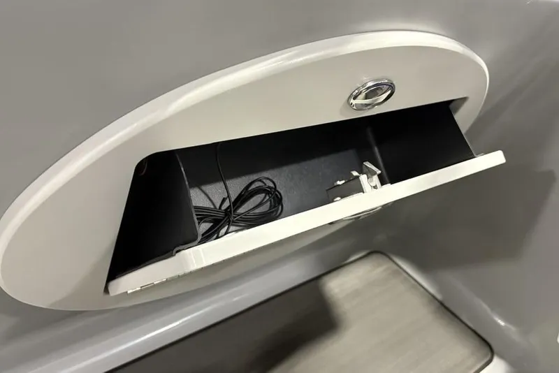 Slide: The Image of Open storage compartment in 2023 Regency 230 DL3 boat interior. - 36