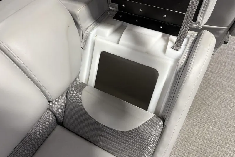Slide: The Image of 2023 Regency 230 DL3 boat seat storage compartment with gray upholstery and integrated design. - 40