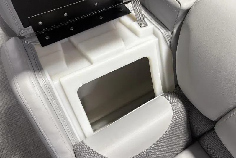 Slide: The Image of 2023 Regency 230 DL3 boat seat storage compartment with open lid, showcasing interior space. - 41