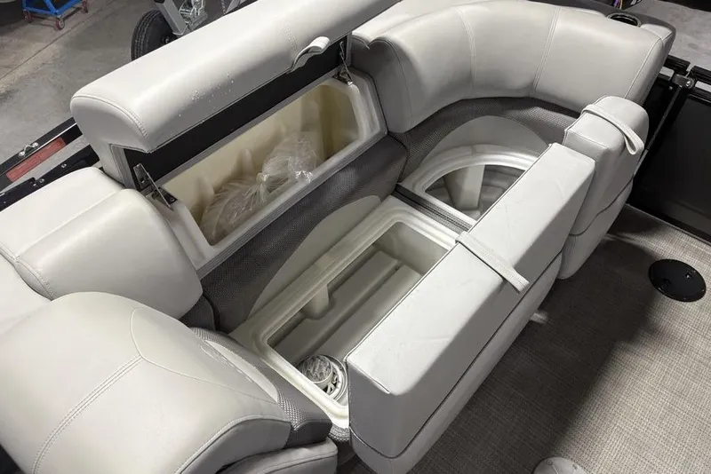 Slide: The Image of 2023 Regency 230 DL3 boat interior with open storage compartments and cushioned seating. - 45
