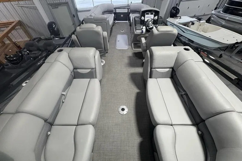 Slide: The Image of 2023 Regency 230 DL3 pontoon boat interior with spacious seating and modern design. - 46