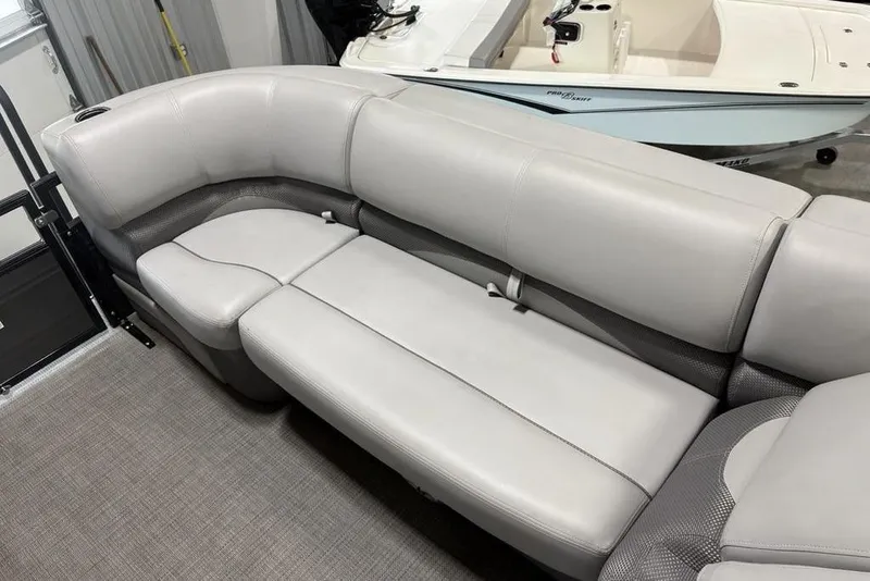 Slide: The Image of Luxurious seating on 2023 Regency 230 DL3 pontoon boat, featuring sleek gray upholstery. - 5