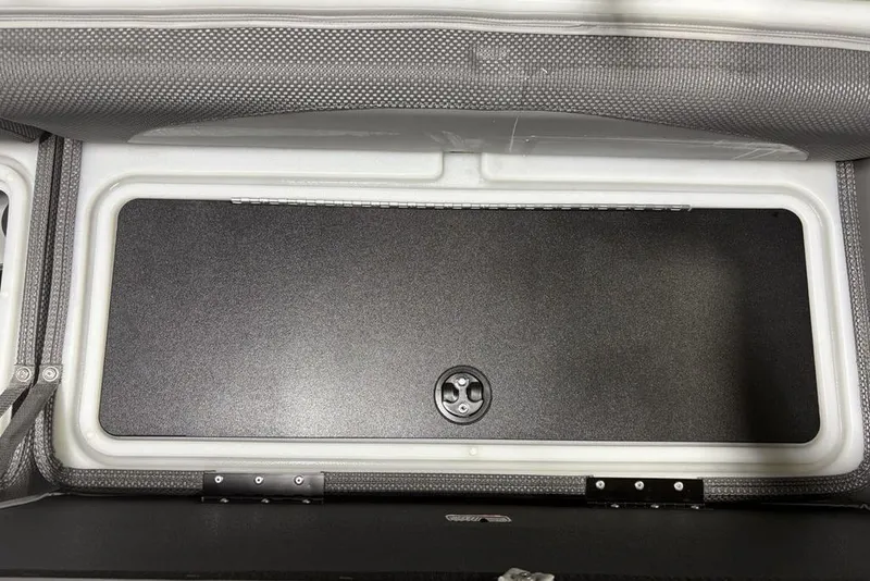Slide: The Image of Storage compartment of 2023 Regency 230 DL3 boat, featuring a secure latch and durable interior. - 9