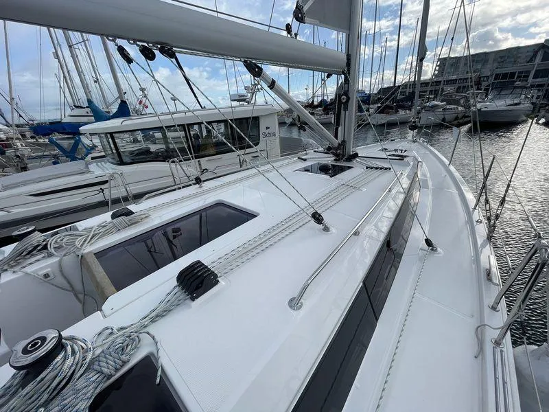 Slide: The Image of 2023 Bavaria C38 sailboat docked in marina, showcasing sleek deck design. - 14