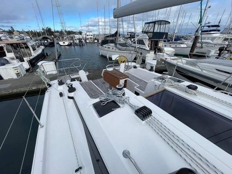 Slide: The Image of Bavaria C38 yacht, 2023 model, docked in a marina with other boats. - 15