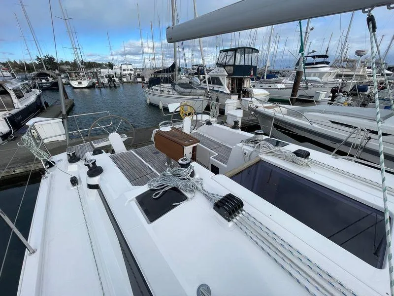 Slide: The Image of 2023 Bavaria C38 yacht docked in a marina, surrounded by other boats. - 16