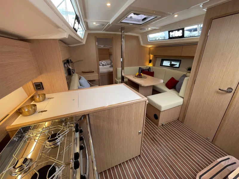 Slide: The Image of 2023 Bavaria C38 yacht interior with modern kitchen and cozy seating area. - 20