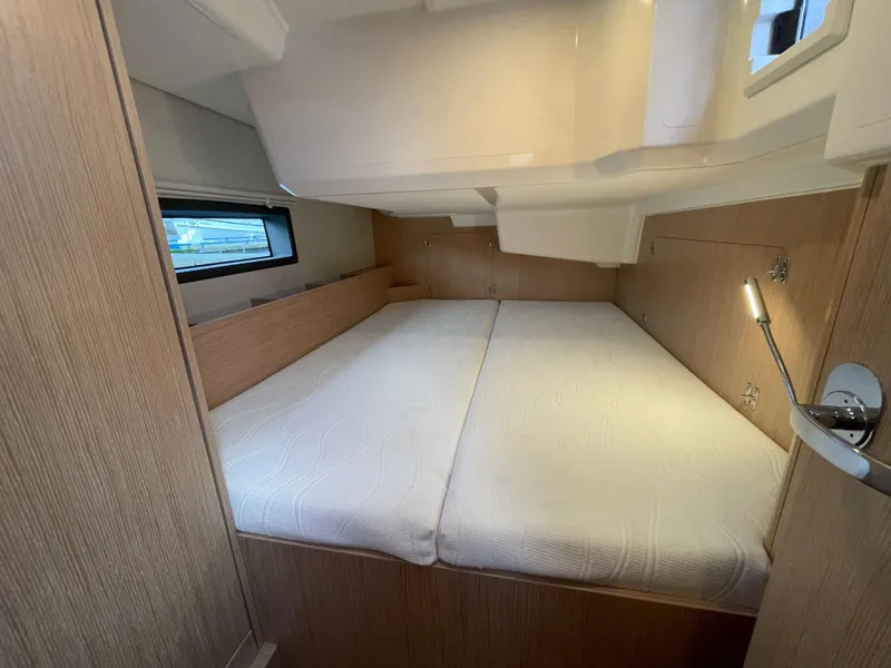 Slide: The Image of 2023 Bavaria C38 yacht cabin with cozy double bed and modern wood finish. - 28