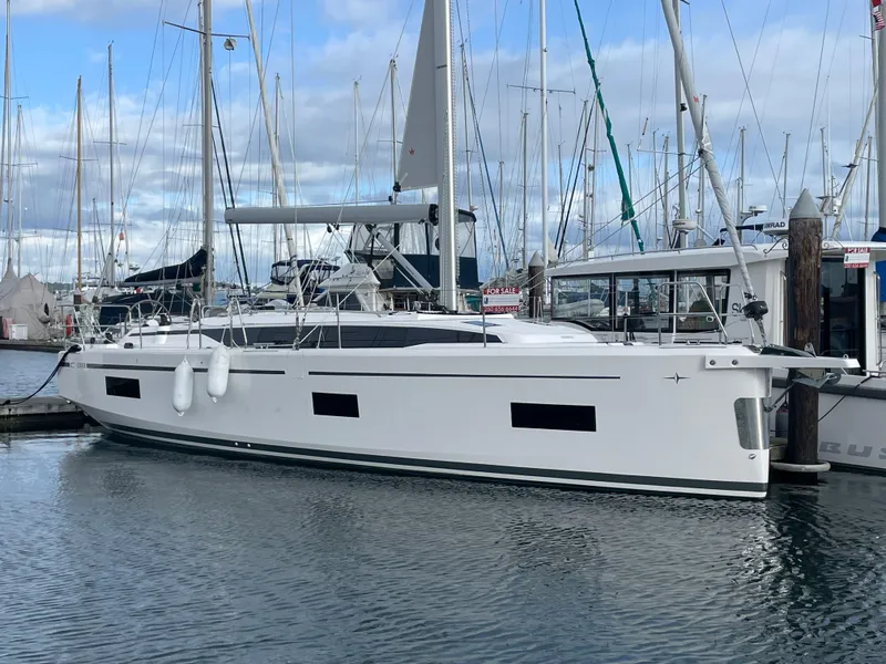 The Image of 2023 Bavaria C38 yacht docked in marina, sleek design, calm waters, cloudy sky. - 9