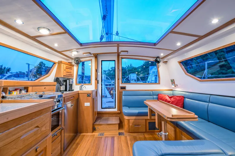 Slide: The Image of Luxurious interior of 2025 Tartan 455 yacht with blue seating and wooden finishes. - 15