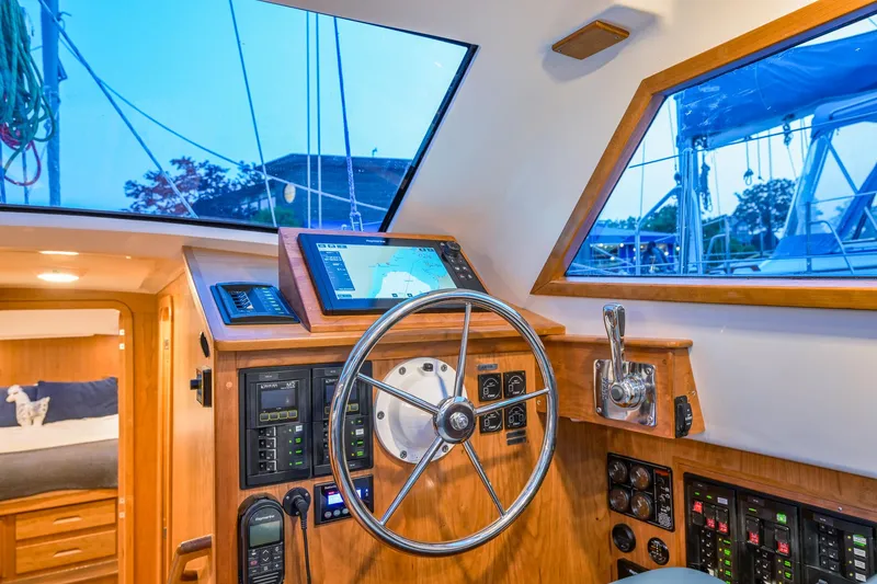 Slide: The Image of Interior helm of 2025 Tartan 455 sailboat with navigation equipment and steering wheel. - 16