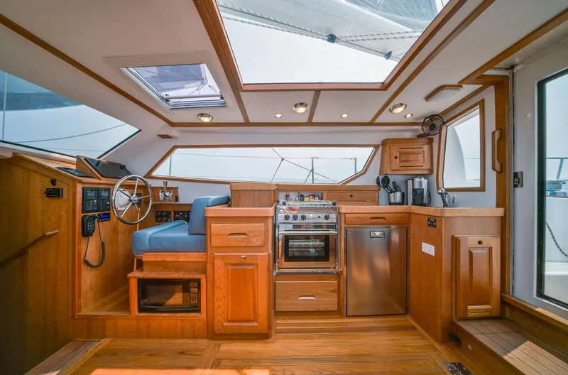 Slide: The Image of Luxurious interior of 2025 Tartan 455 yacht with modern kitchen and navigation area. - 18