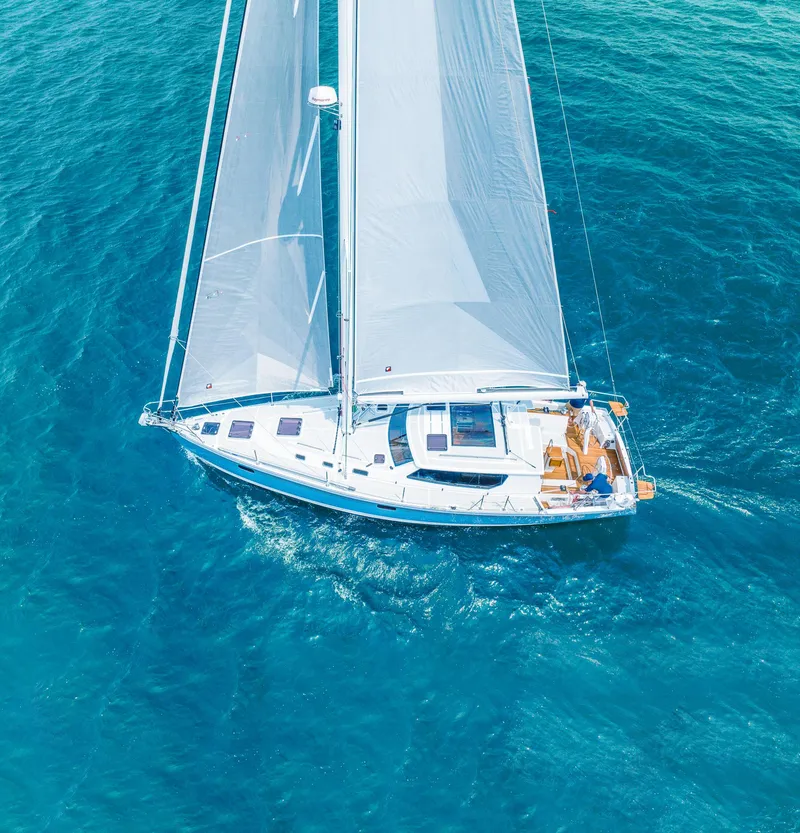 Slide: The Image of Aerial view of 2025 Tartan 455 sailboat cruising on clear blue water. - 1