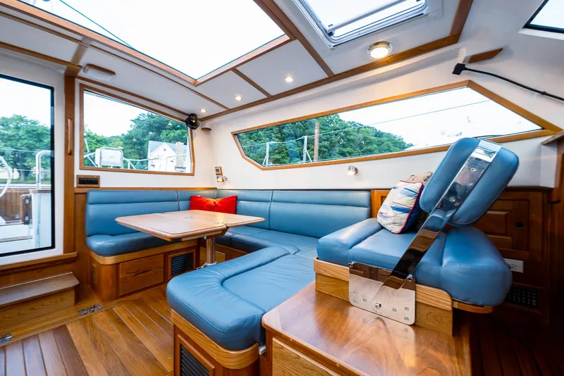 Slide: The Image of Luxurious interior of 2025 Tartan 455 yacht with blue seating and wooden accents. - 16