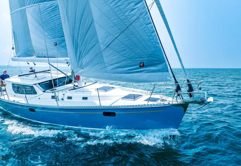 Slide: The Image of 2025 Tartan 455 sailboat cruising on open water. - 2
