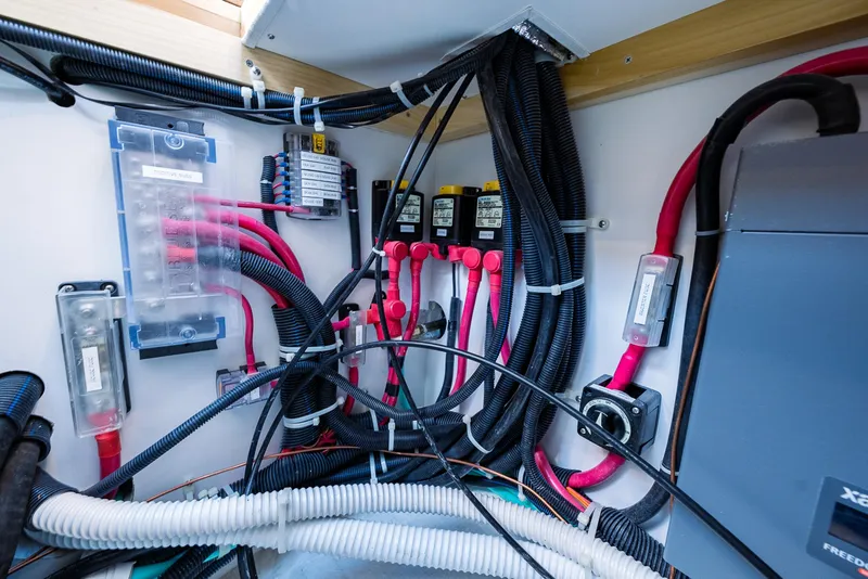 Slide: The Image of Electrical wiring and components inside a 2025 Tartan 455 boat. - 27