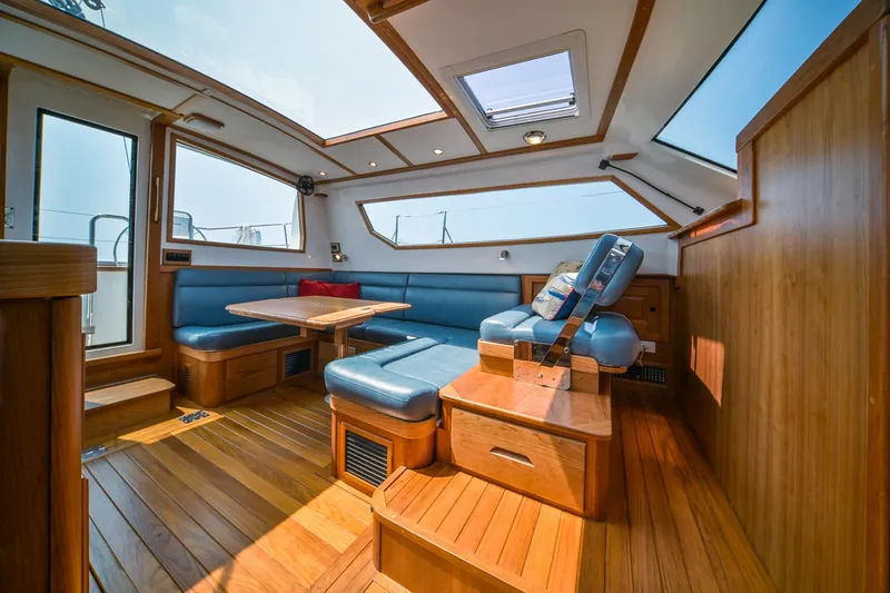 Slide: The Image of Luxurious interior of 2025 Tartan 455 yacht with wooden flooring and blue seating. - 14