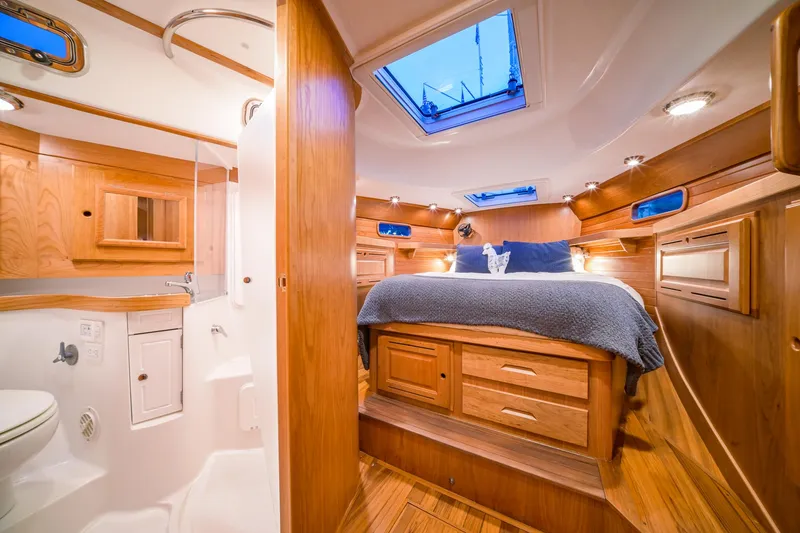 Slide: The Image of Luxurious interior of 2025 Tartan 455 yacht with wooden finishes and skylight. - 16