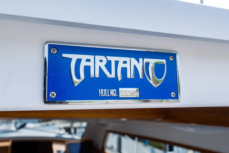 Slide: The Image of Tartan 455 boat nameplate, 2025 model, blue and silver design. - 21