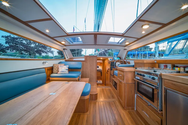 Slide: The Image of Luxurious interior of 2025 Tartan 455 sailboat with modern kitchen and seating area. - 9