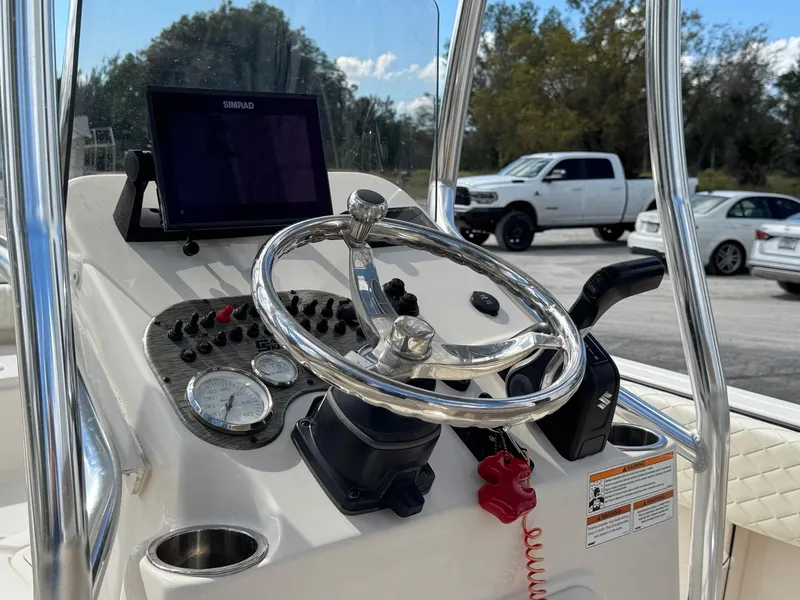 Slide: The Image of 2023 Carolina Skiff 21 Ultra Elite boat dashboard with steering wheel and controls. - 13