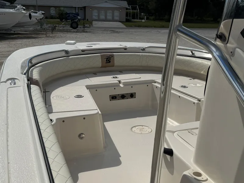 Slide: The Image of 2023 Carolina Skiff 21 Ultra Elite boat interior with cushioned seating and storage compartments. - 14