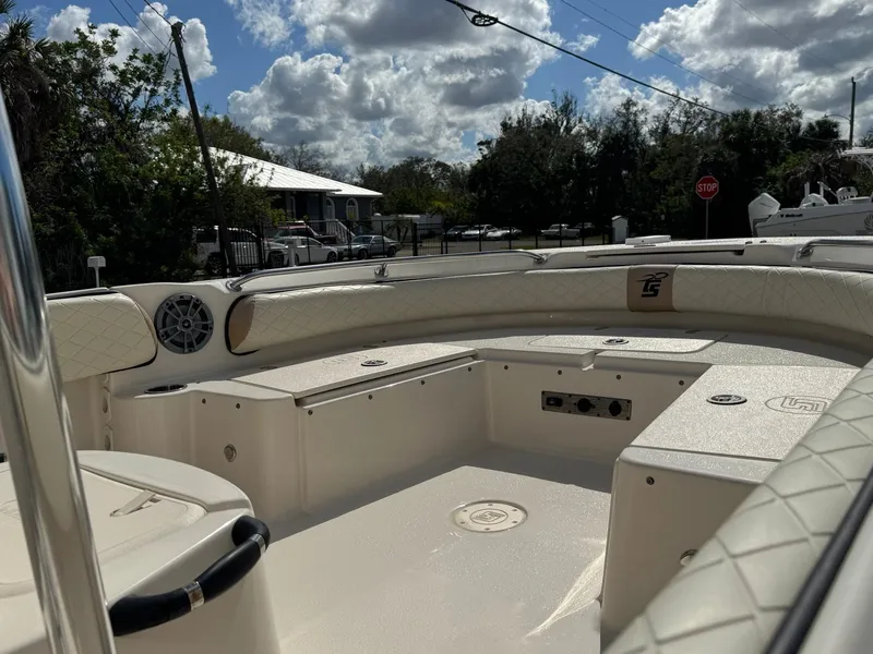 Slide: The Image of 2023 Carolina Skiff 21 Ultra Elite boat interior with cushioned seating and storage compartments. - 15