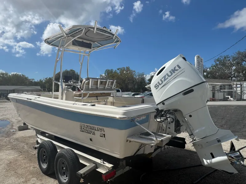 Slide: The Image of 2023 Carolina Skiff 21 Ultra Elite boat with Suzuki outboard motor on trailer. - 3