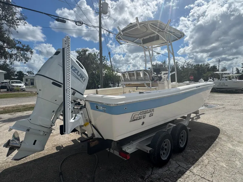 Slide: The Image of 2023 Carolina Skiff 21 Ultra Elite boat with Suzuki outboard motor on trailer. - 4