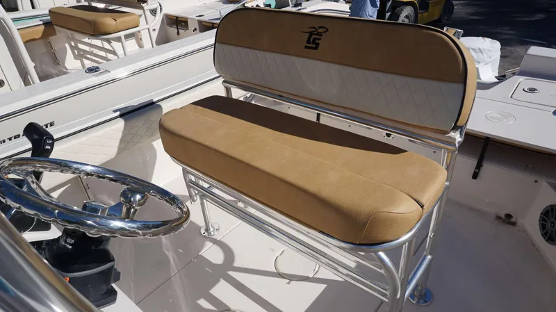 Slide: The Image of 2023 Carolina Skiff 21 Ultra Elite boat interior with tan seating and steering wheel. - 9