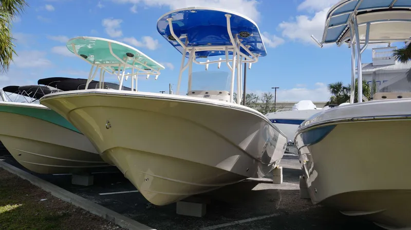 Slide: The Image of 2023 Carolina Skiff 24 Ultra Elite boats displayed in a sunny outdoor setting. - 1