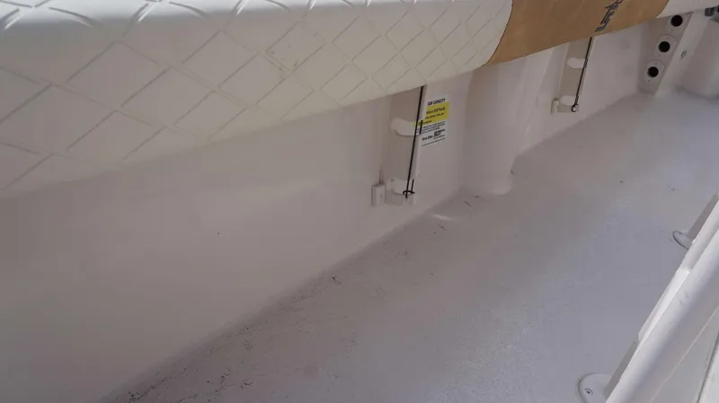 Slide: The Image of 2023 Carolina Skiff 24 Ultra Elite interior detail, featuring white textured flooring. - 12