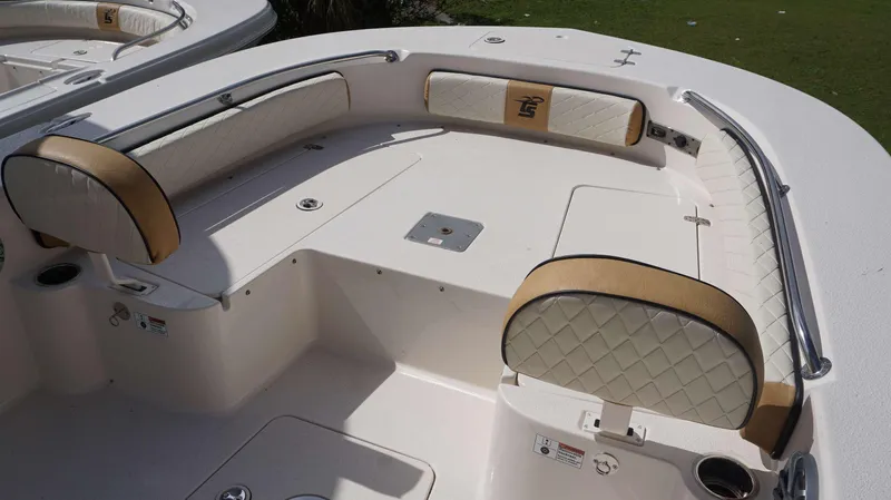 Slide: The Image of 2023 Carolina Skiff 24 Ultra Elite boat interior with cushioned seating and storage. - 15