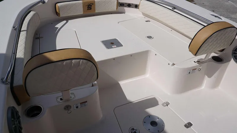 Slide: The Image of 2023 Carolina Skiff 24 Ultra Elite boat interior with cushioned seating and storage compartments. - 16