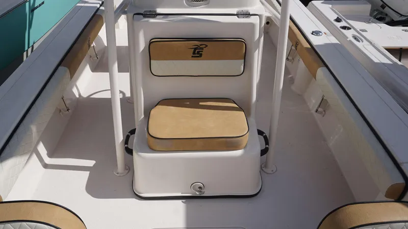 Slide: The Image of 2023 Carolina Skiff 24 Ultra Elite boat interior with tan seating and white accents. - 17