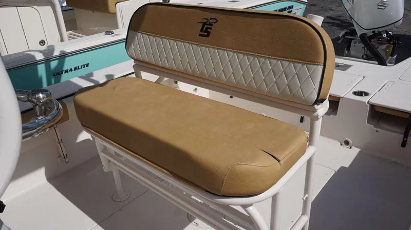 Slide: The Image of 2023 Carolina Skiff 24 Ultra Elite boat seat with tan and white upholstery. - 18
