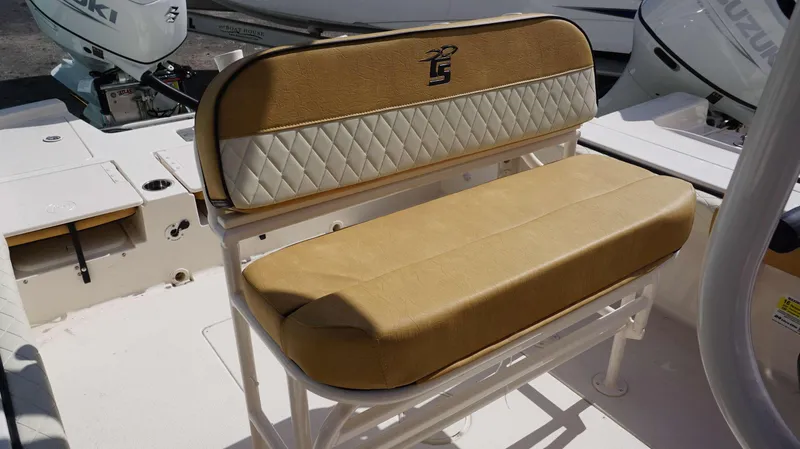 Slide: The Image of 2023 Carolina Skiff 24 Ultra Elite boat seat with tan and white upholstery. - 19