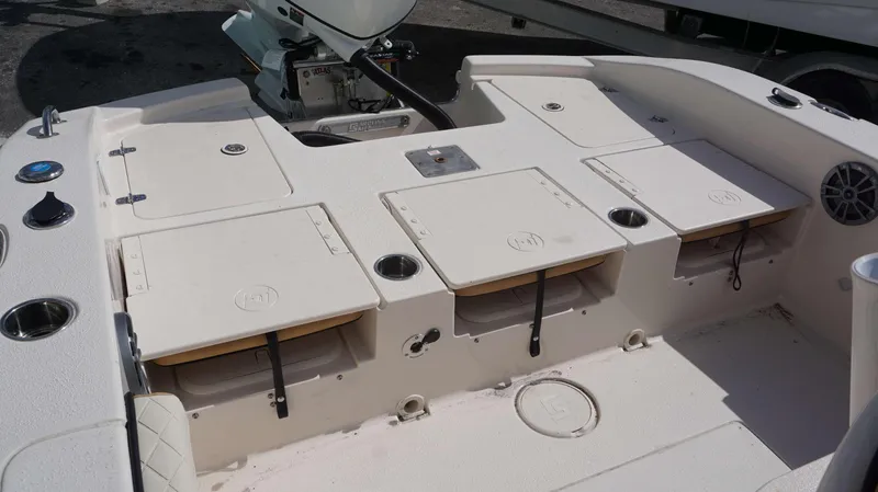Slide: The Image of 2023 Carolina Skiff 24 Ultra Elite boat interior with storage compartments and seating. - 20