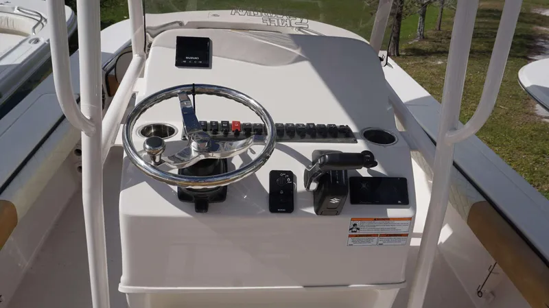 Slide: The Image of 2023 Carolina Skiff 24 Ultra Elite boat console with steering wheel and controls. - 4