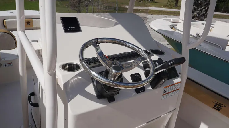 Slide: The Image of 2023 Carolina Skiff 24 Ultra Elite boat console with steering wheel and controls. - 5