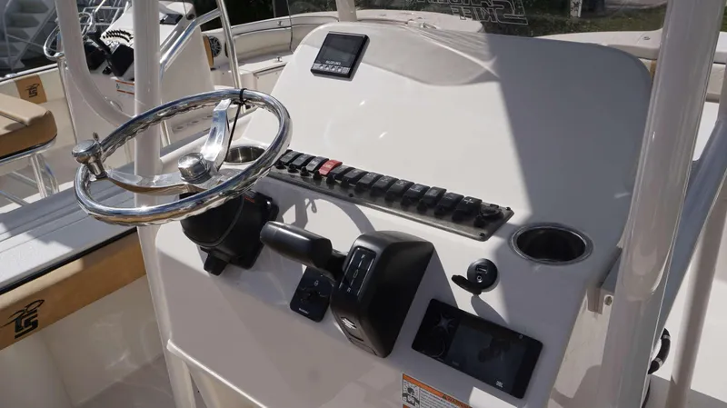 Slide: The Image of 2023 Carolina Skiff 24 Ultra Elite boat console with steering wheel and controls. - 6
